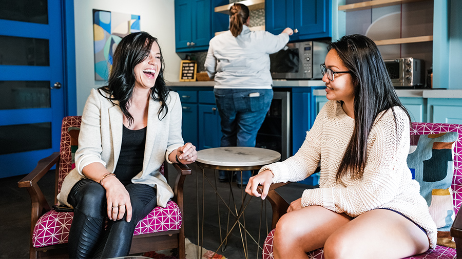 women talking in lounge space at Catalyst Coworking