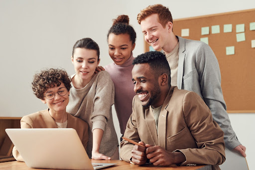 people looking at a laptop computer